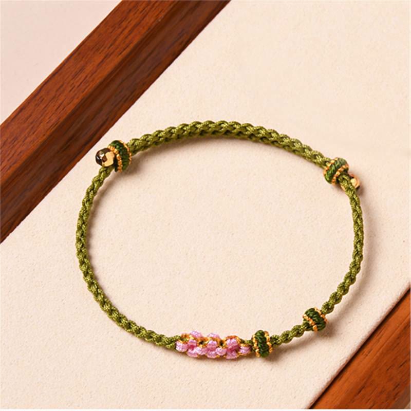 Bracelet tressé en corde de protection en fleur de pêcher fait main par Buddha Stones