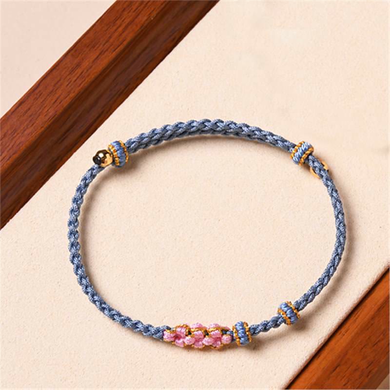 Bracelet tressé en corde de protection en fleur de pêcher fait main par Buddha Stones