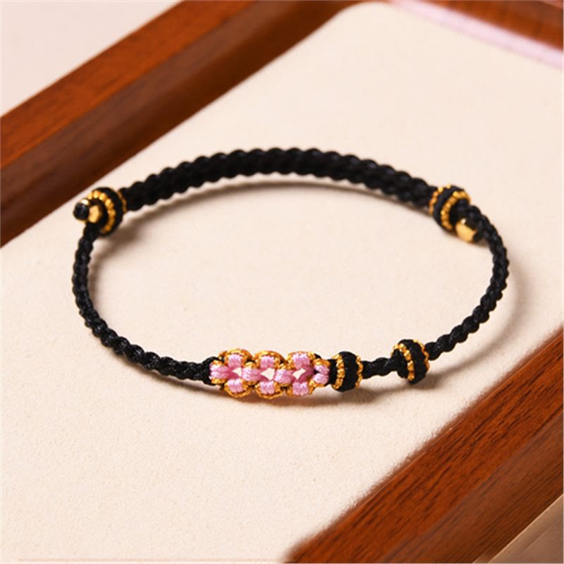 Bracelet tressé en corde de protection en fleur de pêcher fait main par Buddha Stones
