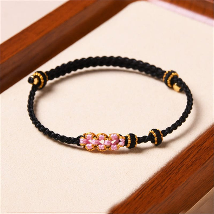 Bracelet tressé en corde de protection en fleur de pêcher fait main par Buddha Stones