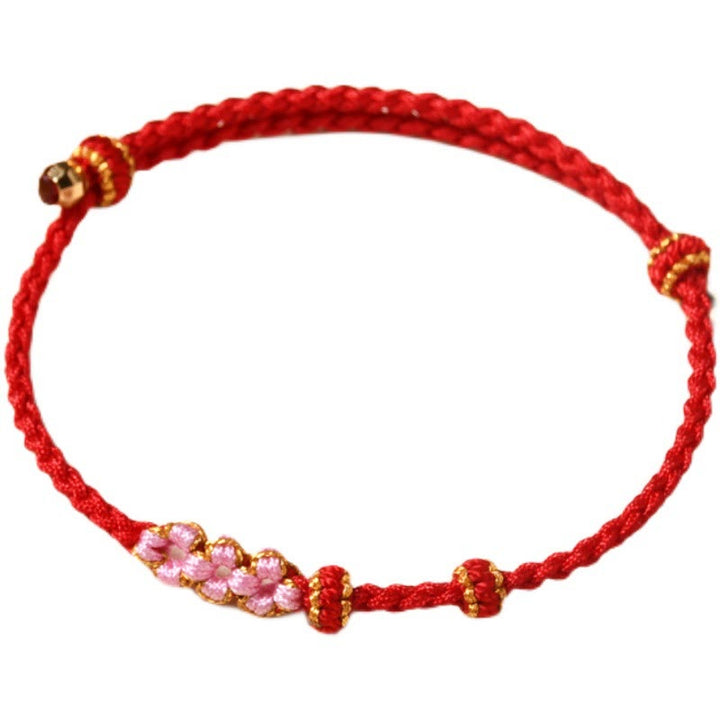 Bracelet tressé en corde de protection en fleur de pêcher fait main par Buddha Stones