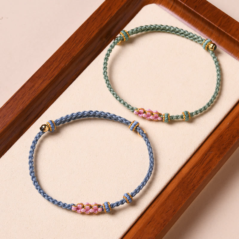 Bracelet tressé en corde de protection en fleur de pêcher fait main par Buddha Stones