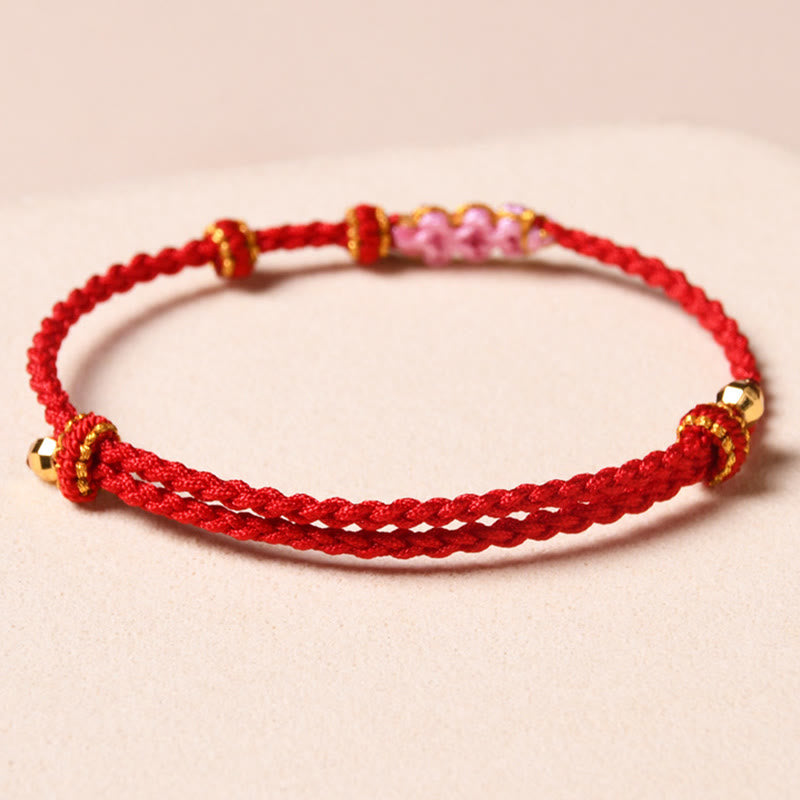 Bracelet tressé en corde de protection en fleur de pêcher fait main par Buddha Stones