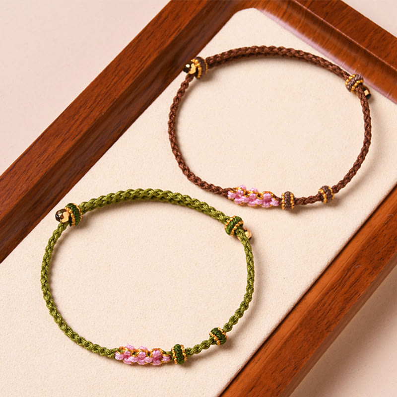 Bracelet tressé en corde de protection en fleur de pêcher fait main par Buddha Stones