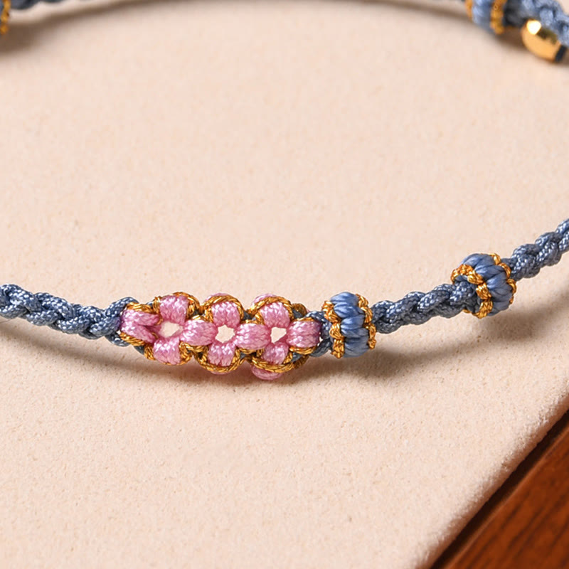 Bracelet tressé en corde de protection en fleur de pêcher fait main par Buddha Stones