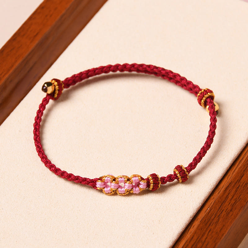 Bracelet tressé en corde de protection en fleur de pêcher fait main par Buddha Stones