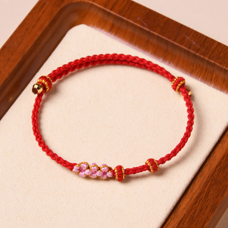 Bracelet tressé en corde de protection en fleur de pêcher fait main par Buddha Stones
