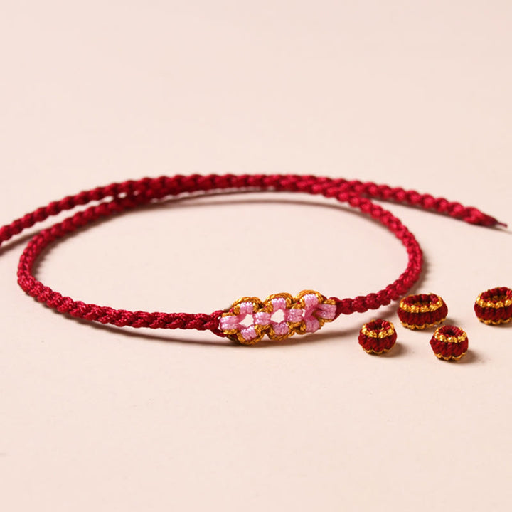Bracelet tressé en corde de protection en fleur de pêcher fait main par Buddha Stones