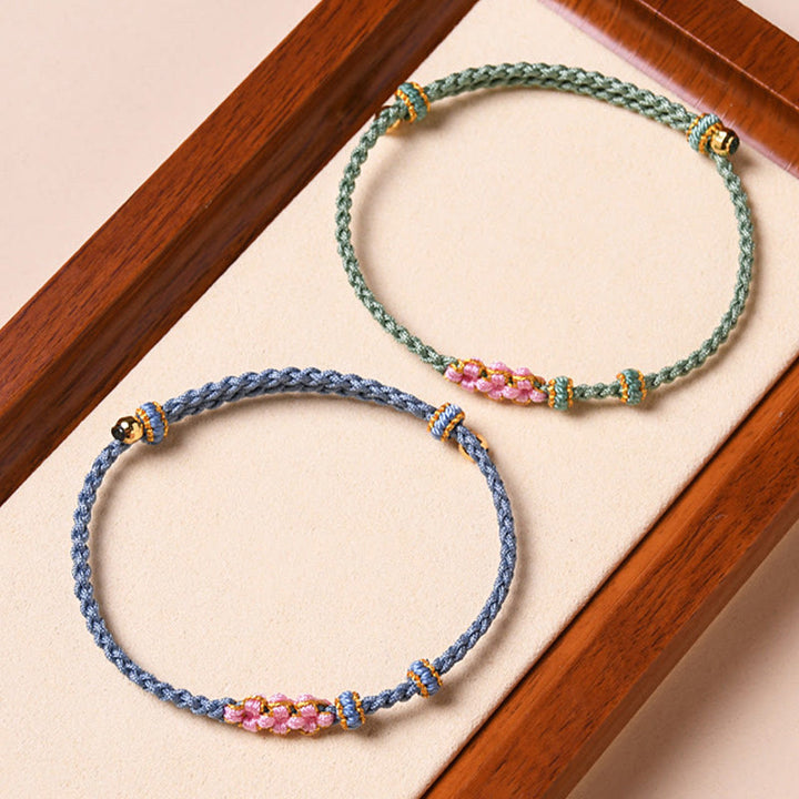 Bracelet tressé en corde de protection en fleur de pêcher fait main par Buddha Stones