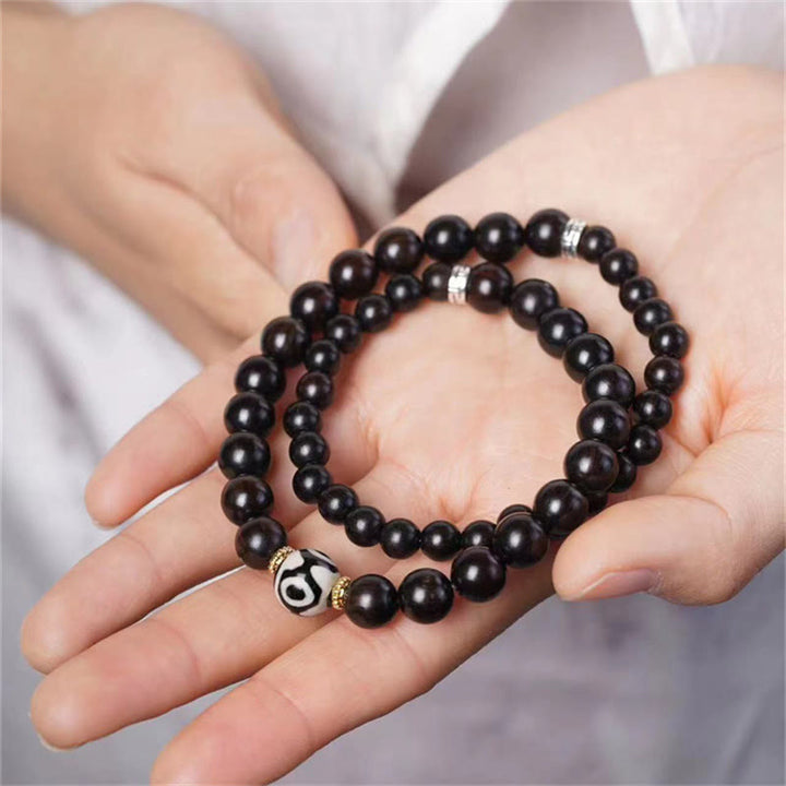 Bracelet double tour en perles dzi en bois d'ébène tibétain et Buddha Stones