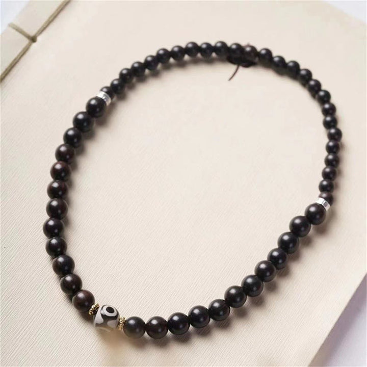 Bracelet double tour en perles dzi en bois d'ébène tibétain et Buddha Stones