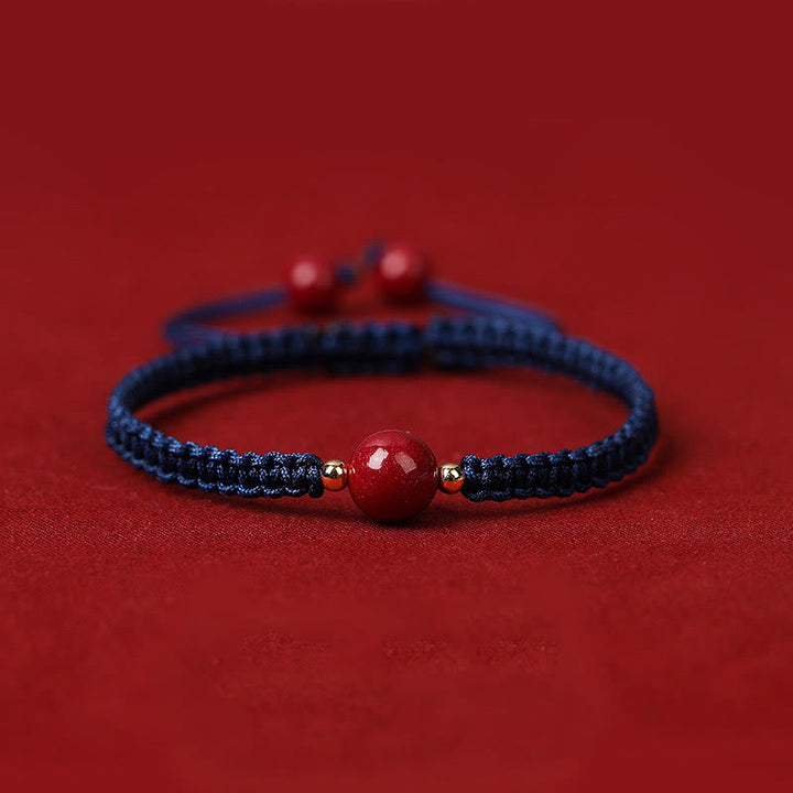 Bracelet porte-bonheur en perles de cinabre avec cordon rouge et Buddha Stones