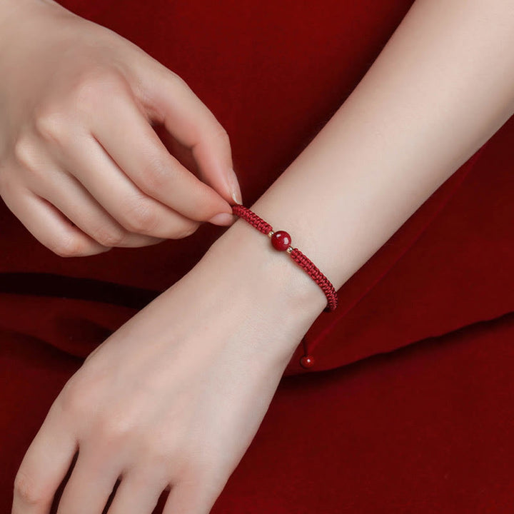Bracelet porte-bonheur en perles de cinabre avec cordon rouge et Buddha Stones