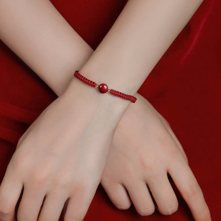 Bracelet porte-bonheur en perles de cinabre avec cordon rouge et Buddha Stones
