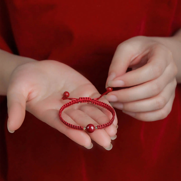 Bracelet porte-bonheur en perles de cinabre avec cordon rouge et Buddha Stones