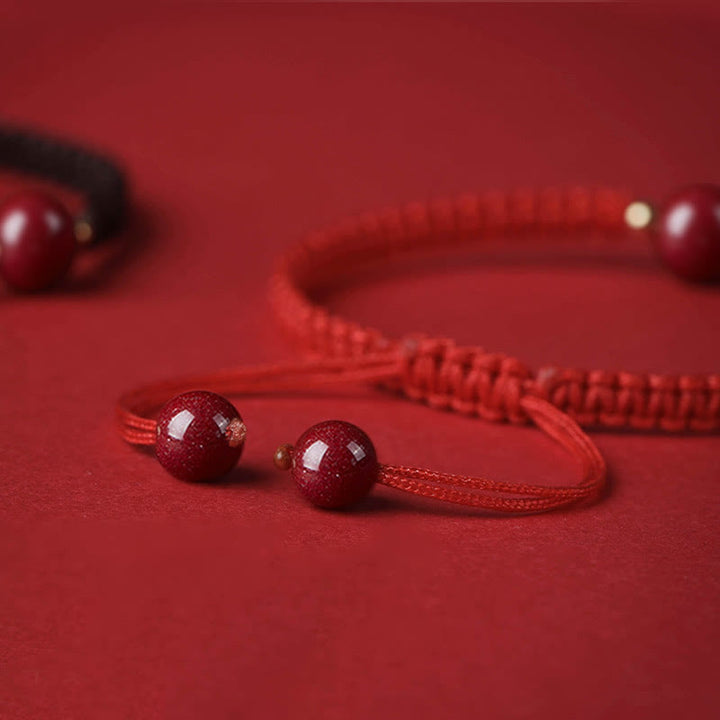 Bracelet porte-bonheur en perles de cinabre avec cordon rouge et Buddha Stones