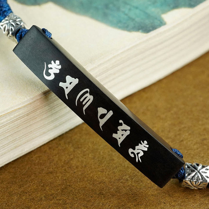 Bracelet de protection incrusté d'argent en bois d'ébène et de Buddha Stones