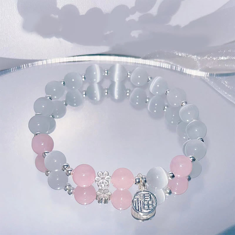 Bracelet de soutien à breloques en forme de Buddha Stones et de personnage Fu en cristal œil de chat et fleur de pêcher