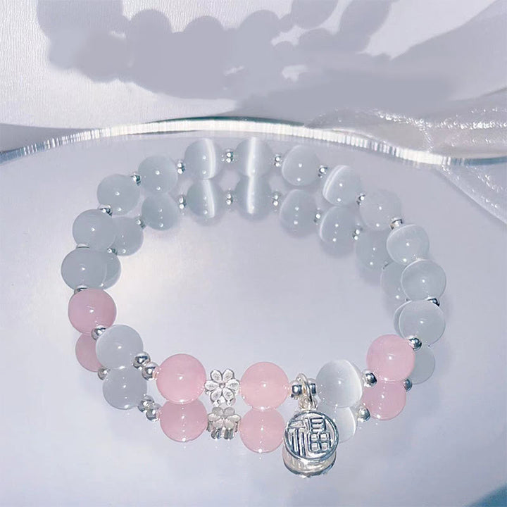 Bracelet de soutien à breloques en forme de Buddha Stones et de personnage Fu en cristal œil de chat et fleur de pêcher