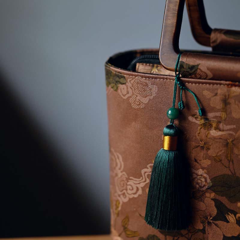 Sac à main vintage en Buddha Stones avec fleurs brunes et feuilles de bambou vertes et poignées en bois et fermeture éclair
