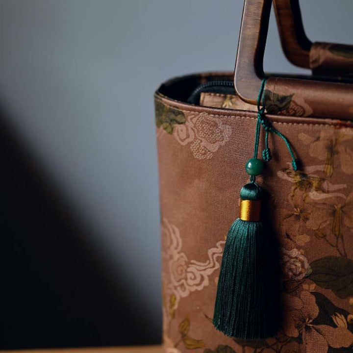 Sac à main vintage en Buddha Stones avec fleurs brunes et feuilles de bambou vertes et poignées en bois et fermeture éclair