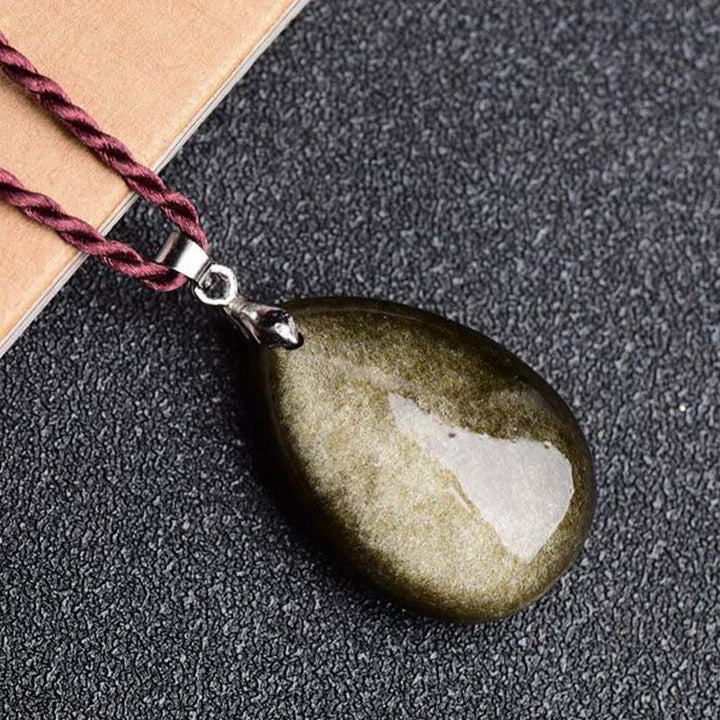 Collier pendentif goutte d'eau en obsidienne noire et dorée avec Buddha Stones