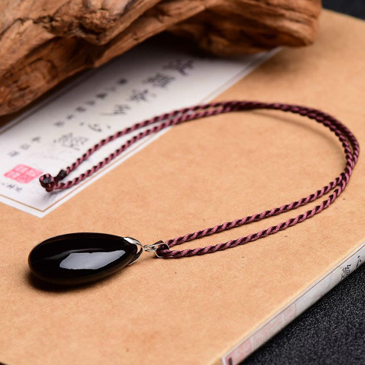 Collier pendentif goutte d'eau en obsidienne noire et dorée avec Buddha Stones