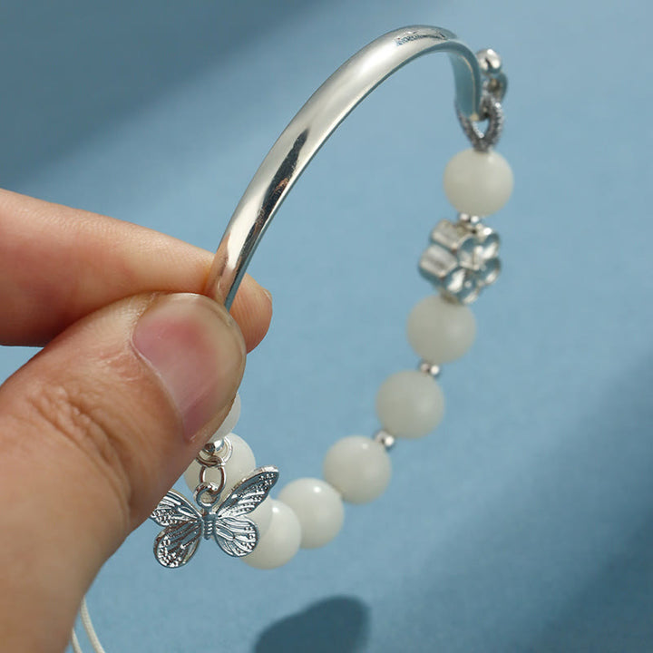 Bracelet jonc porte-bonheur en pierres de Buddha Stones et graines de Bodhi, papillon, lotus