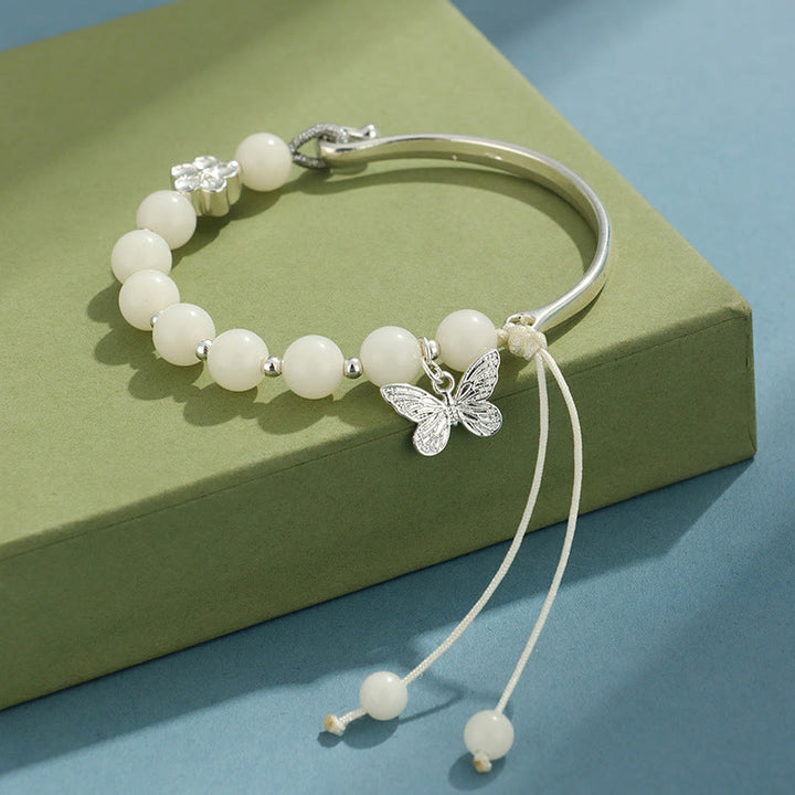 Bracelet jonc porte-bonheur en pierres de Buddha Stones et graines de Bodhi, papillon, lotus