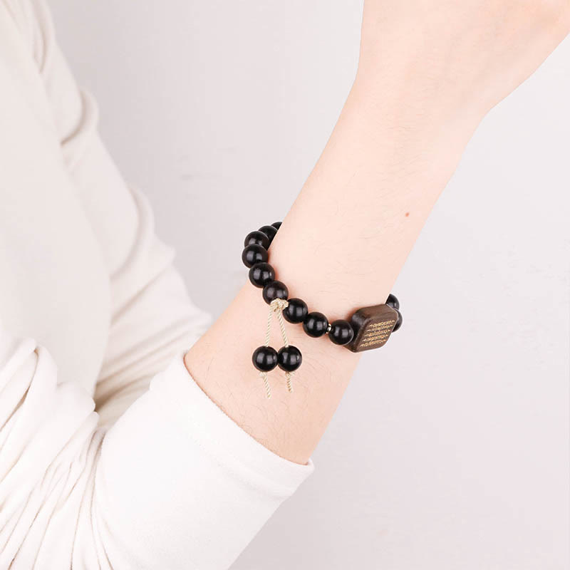Bracelet de paix gravé en bois d'ébène avec Buddha Stones