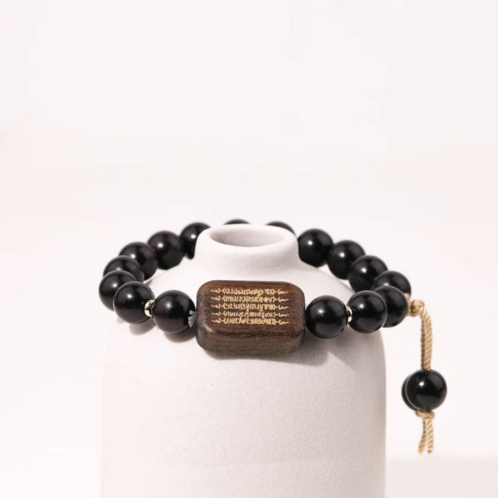 Bracelet de paix gravé en bois d'ébène avec Buddha Stones