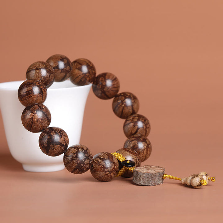 Bracelet de paix intérieure en bois de fleur de prunier et Buddha Stones