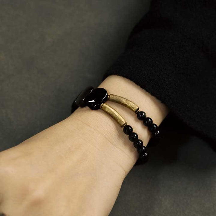 Bracelet renforcé en obsidienne noire et dorée avec Buddha Stones