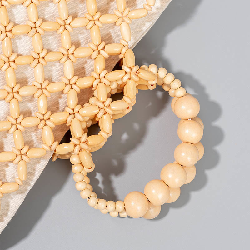 Sac à main en perles de bois creuses en maille tressée avec fil de pêche tissé à la main en Buddha Stones