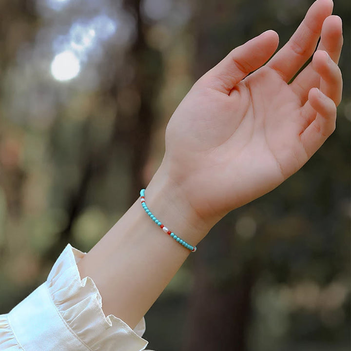 Bracelet de protection en petites perles d'agate rouge turquoise Buddha Stones