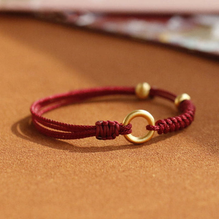 Bracelet en fil rouge avec boucle de paix et Buddha Stones
