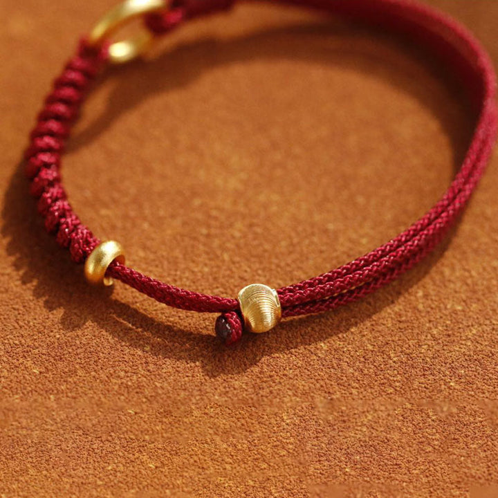 Bracelet en fil rouge avec boucle de paix et Buddha Stones