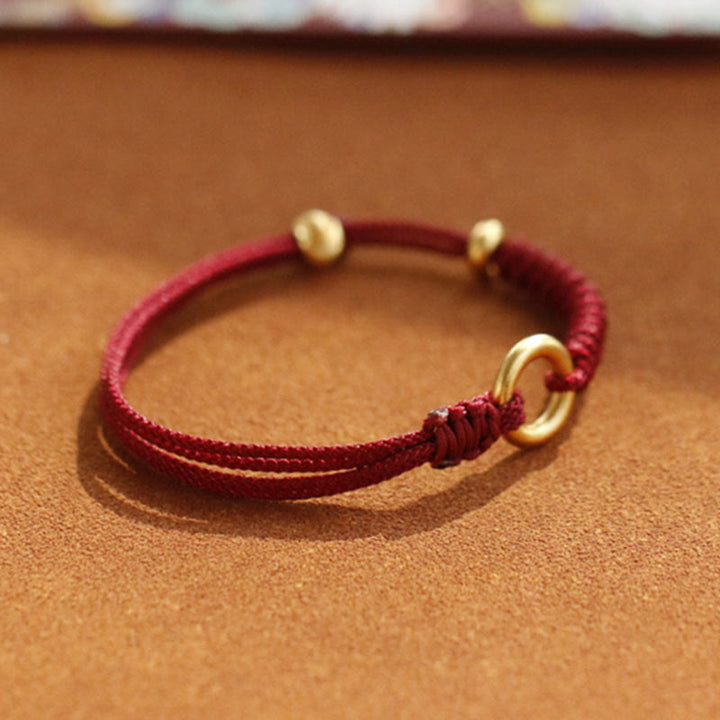 Bracelet en fil rouge avec boucle de paix et Buddha Stones