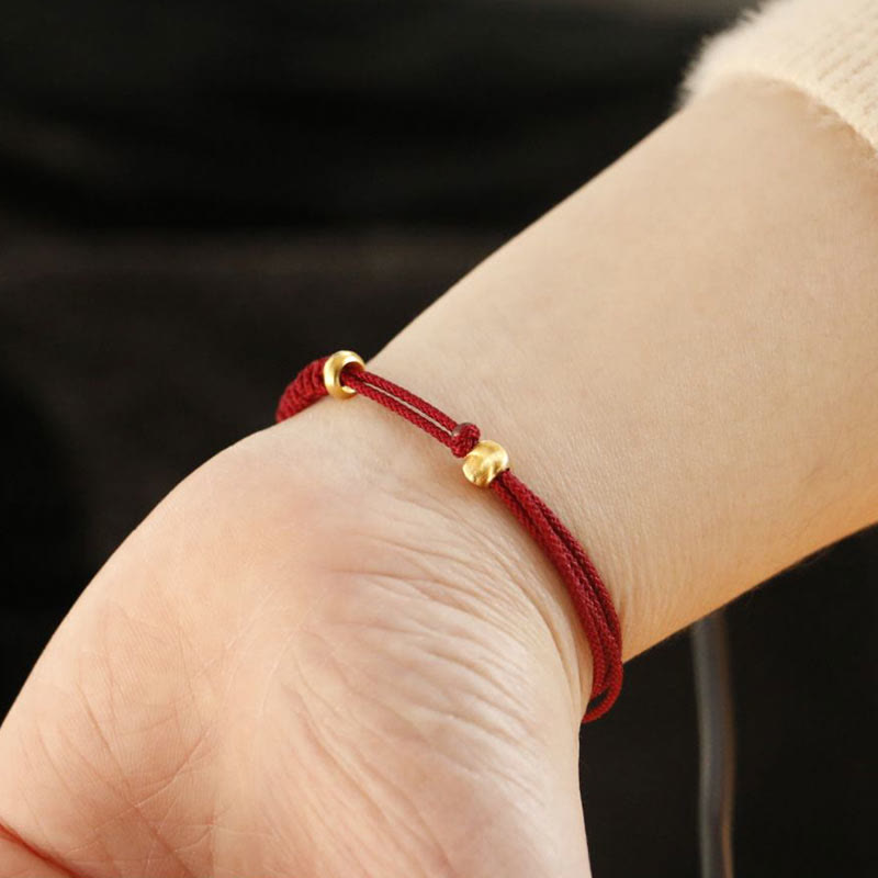 Bracelet en fil rouge avec boucle de paix et Buddha Stones
