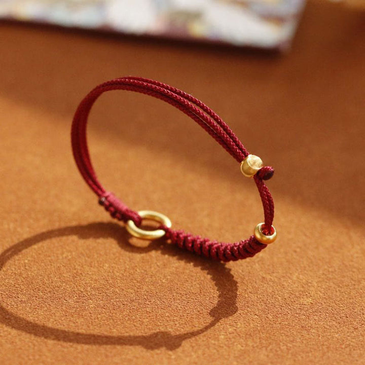 Bracelet en fil rouge avec boucle de paix et Buddha Stones