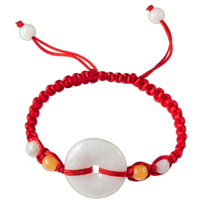 Bracelet en fil rouge avec boucle de paix en jade et Buddha Stones