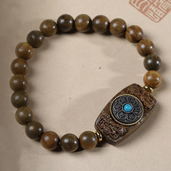 Bracelet de paix en six mots vrais en bois de santal rouge et vert avec petites feuilles de Buddha Stones