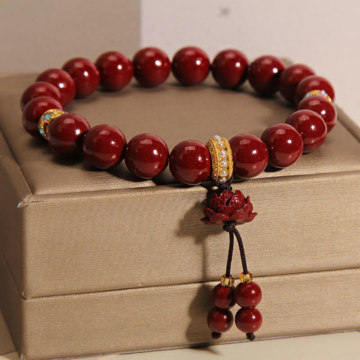 Bracelet à breloques et bénédictions de lotus en Buddha Stones et cinabre
