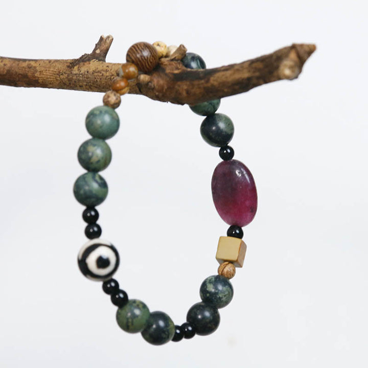 Bracelet de puissance et de succès en perles dzi à trois yeux en agate verte de Buddha Stones