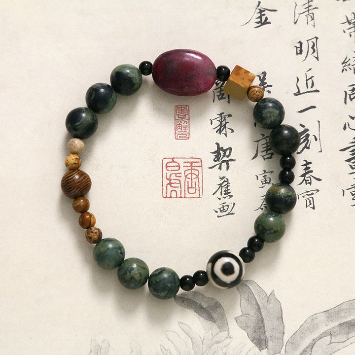 Bracelet de puissance et de succès en perles dzi à trois yeux en agate verte de Buddha Stones