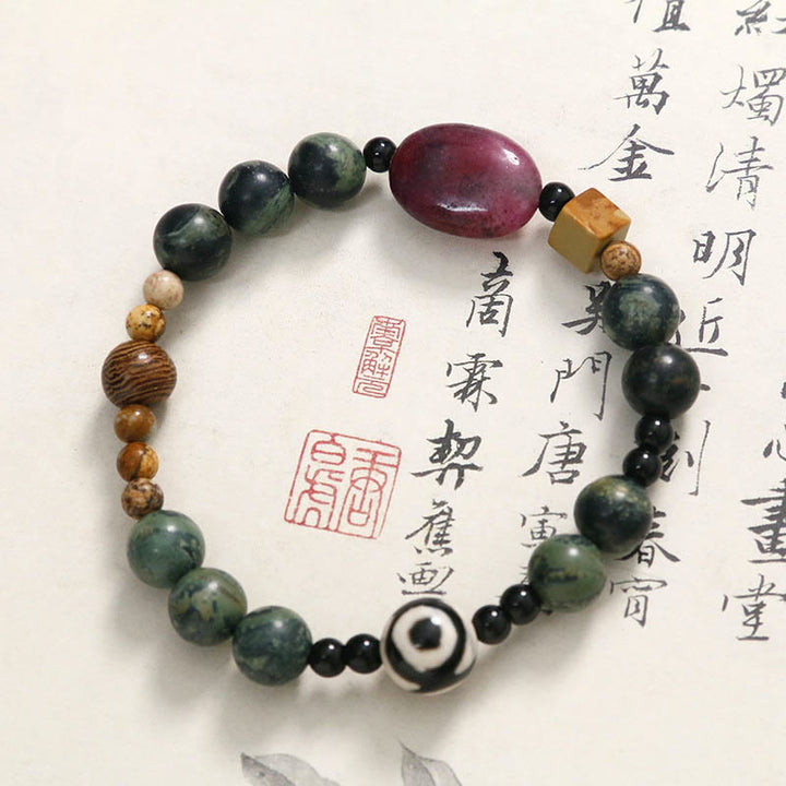 Bracelet de puissance et de succès en perles dzi à trois yeux en agate verte de Buddha Stones