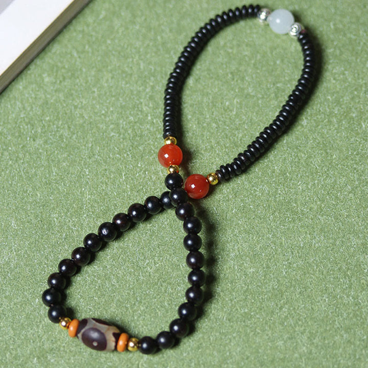 Bracelet double tour en perles de santal et dzi en ébène et bois de santal vert Buddha Stones