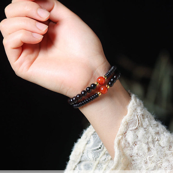 Bracelet double tour en perles de santal et dzi en ébène et bois de santal vert Buddha Stones