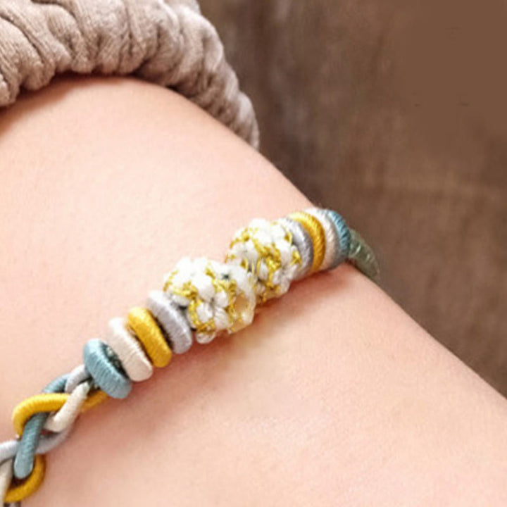 Bracelet de connexion en fleur de pêcher avec quatre Buddha Stones