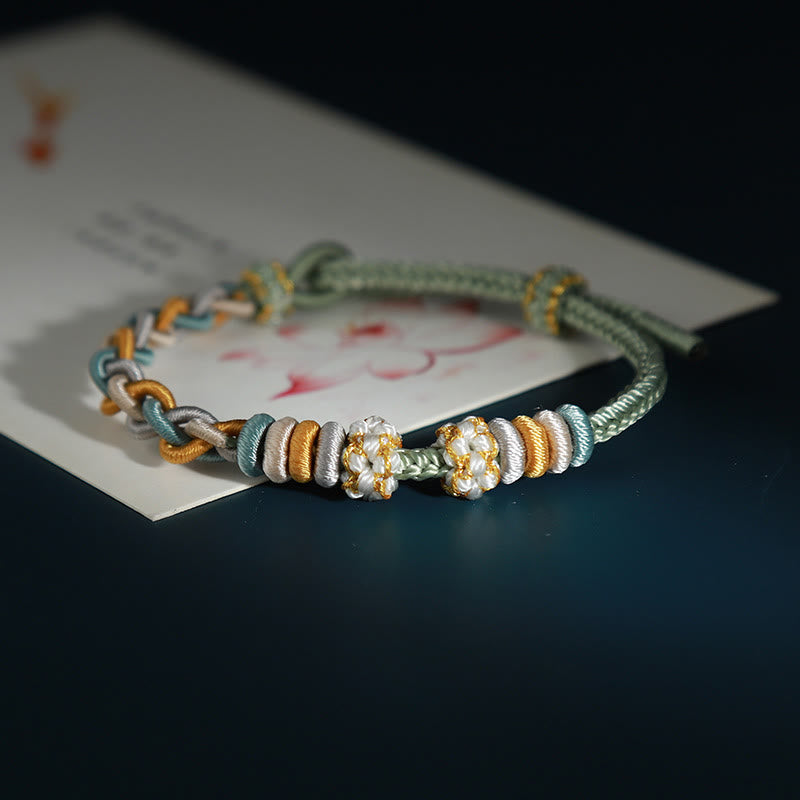 Bracelet de connexion en fleur de pêcher avec quatre Buddha Stones